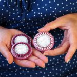 A Woman Holds Several Packs Of Hormonal Pills In Her Hands. Roun